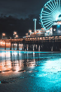 Illuminated ferris wheel at night