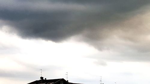 Low angle view of silhouette building against sky