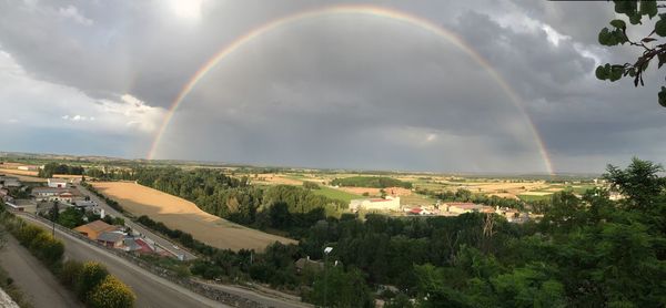 Panoramic view of rainbow over city buildings