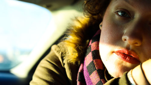 Close-up portrait of young woman looking away