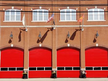 Red windows on wall of building