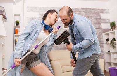 Young couple holding hands while standing in laptop