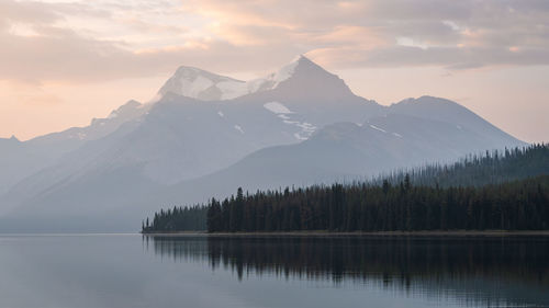 Scenic view of lake and mountains against sky during sunset