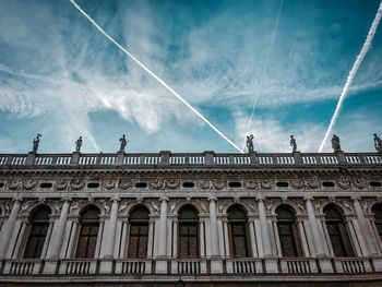 Low angle view of building against cloudy sky