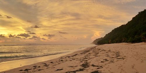 Scenic view of beach against sky during sunset