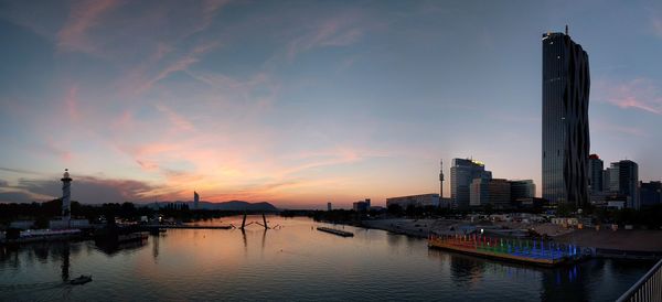 Panoramic view of city buildings against sky during sunset