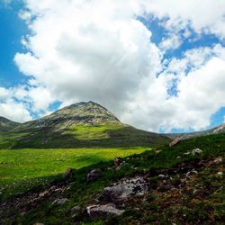 Scenic view of mountains against cloudy sky