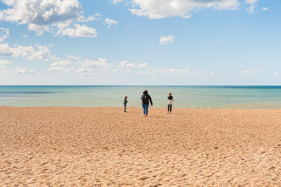 People on beach against sky