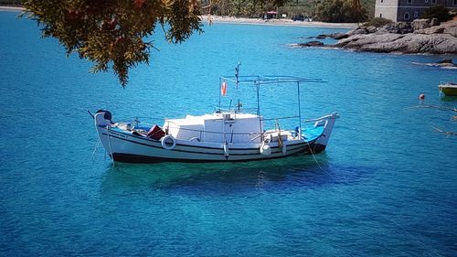 Boats in sea against blue sky