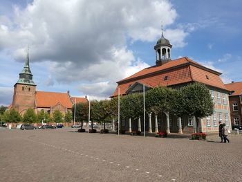 Street amidst buildings in city against sky