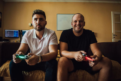 Friends playing video game at home