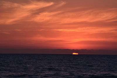 Scenic view of sea against orange sky