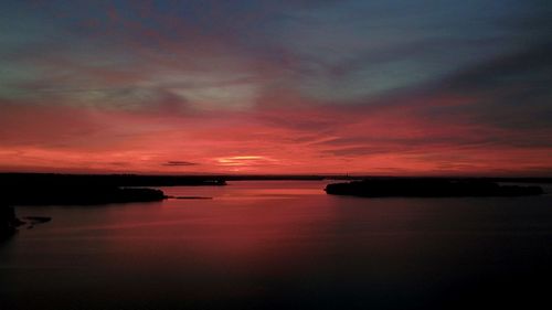 Scenic view of sea against dramatic sky during sunset