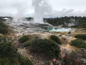 Scenic view of waterfall against sky