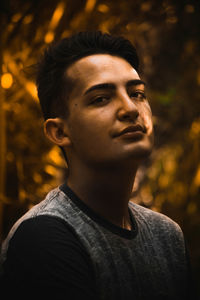 Portrait of confident young man in forest