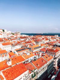 High angle view of townscape by sea against sky