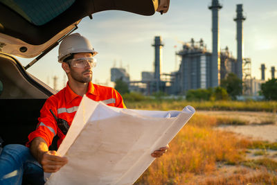 Engineer looking at refinery plans.