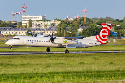 Airplane on field against sky