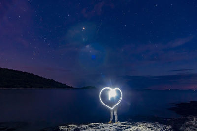 Scenic view of sea against sky at night