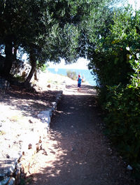 Low section of man walking in water