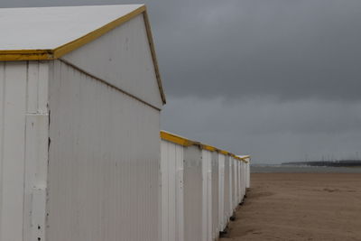 Hut on beach against sky