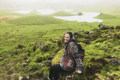 Young woman enjoying at volcanic crater corvo, azores, portugal