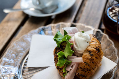 Croissant with ham and cream cheese filling, breakfast in italy