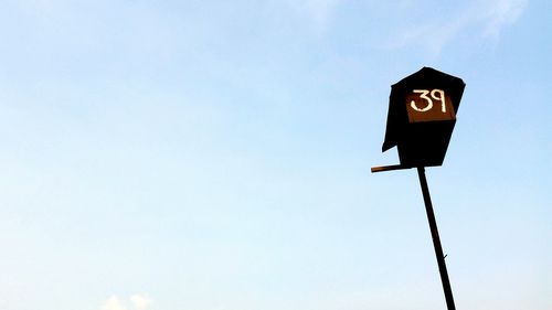 Low angle view of street light against sky