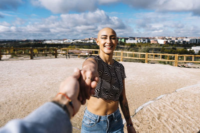 Young couple holding hands at park