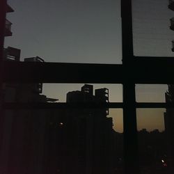 Silhouette built structure at sunset