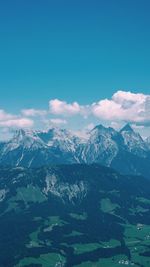 Scenic view of mountains against blue sky