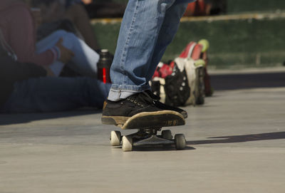 Low section of man skateboarding on skateboard