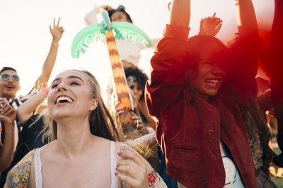 Cheerful audience enjoying at music concert in summer