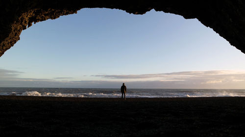 Silhouette of man standing on beach