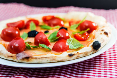 Close-up of pizza in plate on table