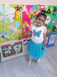 Portrait of smiling girl standing on floor