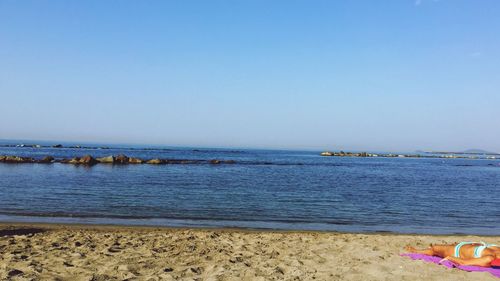 Scenic view of beach against blue sky