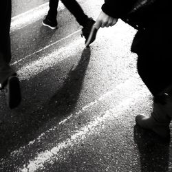 Low section of people standing on road