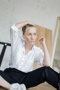 Woman looking away while sitting at home