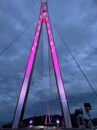 Low angle view of suspension bridge against sky
