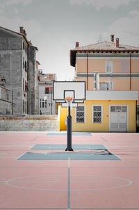 Basketball hoop against sky in city