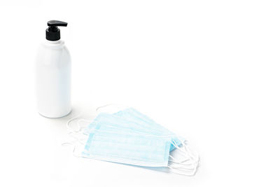 Close-up of glass bottle on white background