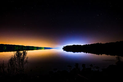 Scenic view of lake against sky at night