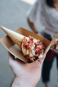 Close-up of hand holding ice cream