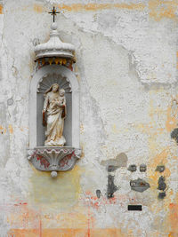 Statues on wall of building