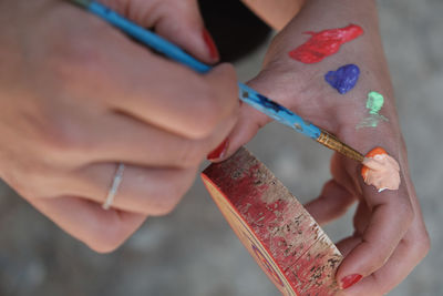 Cropped hand of man holding drink