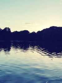 Scenic view of lake against sky at sunset