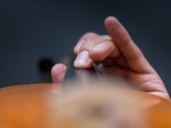 Close-up of human hand against black background