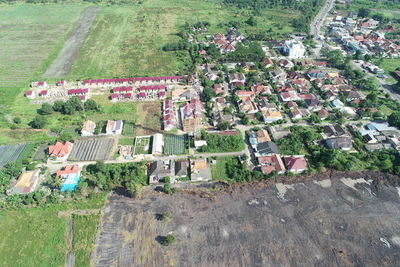 High angle view of trees and houses on field