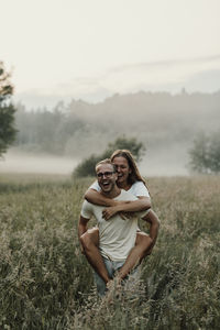 Man giving girlfriend piggyback ride